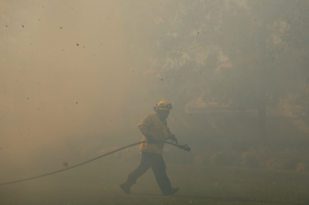 FILE - A firefighter works as the Sandy Fire approaches May 19, 2026, in Simi Valley, Calif. (AP Photo/Caroline Brehman, File)