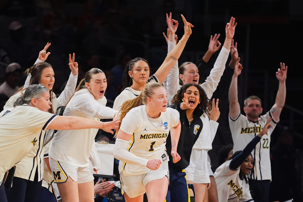 Michigan players celebrate a three-pointer by Olivia Olson (1) in the second half in the Sweet 16 of the NCAA college basketball tournament against Louisville, Saturday, March 28, 2026, in Fort Worth, Texas. (AP Photo/LM Otero)