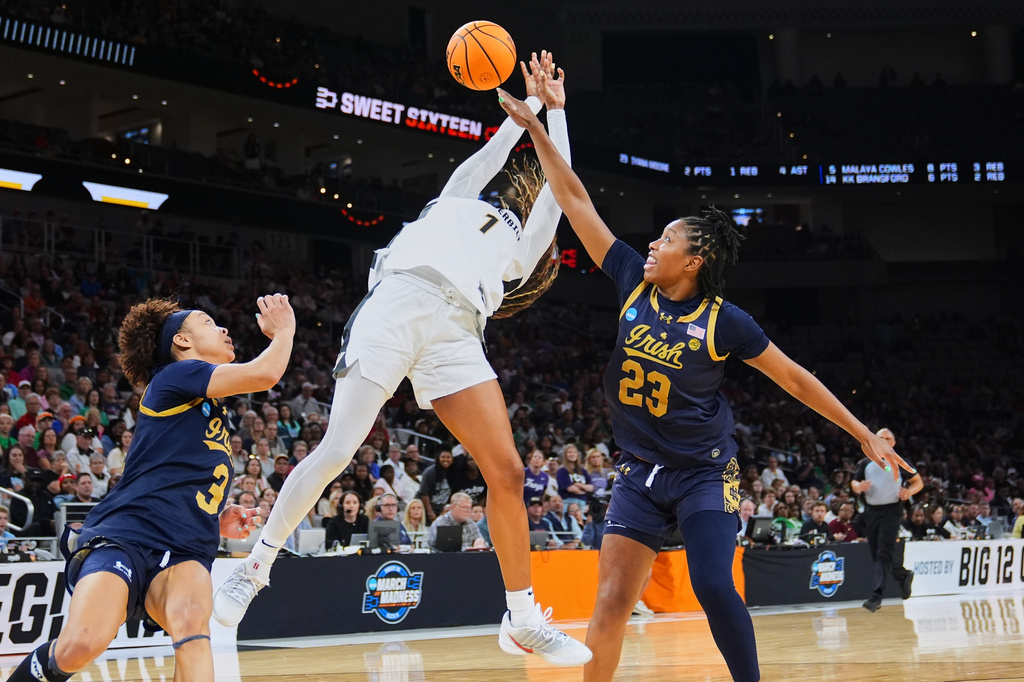 Vanderbilt guard Mikayla Blakes (1) takes a shot as Notre Dame's Hannah Hidalgo (3) and Iyana Moore (23) defend in the second half in the Sweet 16 of the NCAA college basketball tournament, Friday, March 27, 2026, in Fort Worth, Texas. (AP Photo/Julio Cortez)
