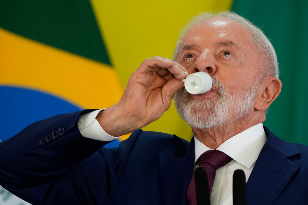 Brazilian President Luiz Inacio Lula da Silva takes a sip of coffee during a year-end press conference at Planalto presidential palace in Brasilia, Brazil, Thursday, Dec. 18, 2025. (AP Photo/Eraldo Peres)