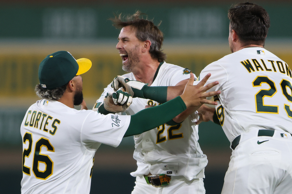 Athletics' Jeff McNeil, middle, is mobbed by his teammates after hitting a walk off RBI single during the ninth inning of a baseball game against the Toronto Blue Jays Monday, Sept. 7, 2026, in West Sacramento, Calif. (AP Photo/Scott Marshall)