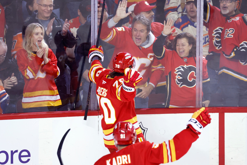Calgary Flames' Ryan Lomberg celebrates his goal against the Edmonton Oilers with fans during third period NHL hockey action in Calgary, Alberta, Wednesday, Feb. 4, 2026. (Larry MacDougal/The Canadian Press via AP)