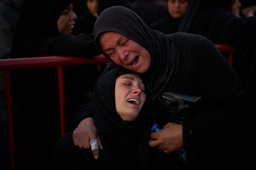 Mourners react during the funeral of 13 state security officers who were killed the previous day in an Israeli strike in Lebanon’s coastal city of Sidon, Saturday, April 11, 2026. (AP Photo/Emilio Morenatti)