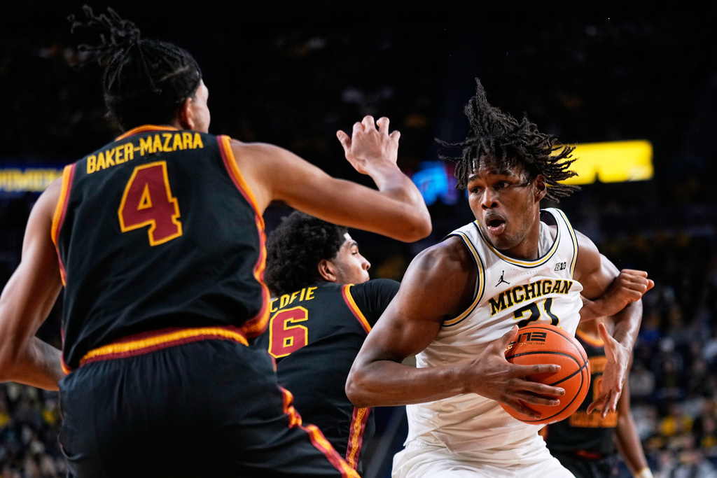 Michigan forward Morez Johnson Jr., right, shoots against Southern California guard Chad Baker-Mazara during the second half of an NCAA college basketball game, Friday, Jan. 2, 2026, in Ann Arbor, Mich. (AP Photo/Ryan Sun)