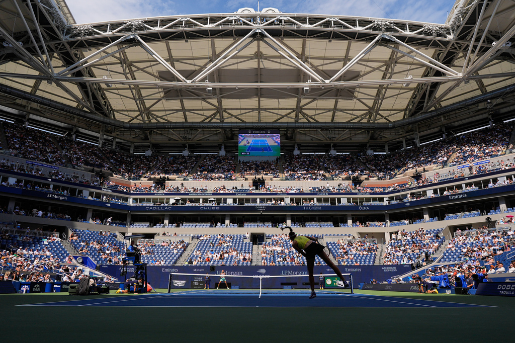 Elena Rybakina, of Kazakhstan, follows through on a serve to Qinwen Zheng, of China, during the quarterfinal round of the U.S. Open tennis championships, Wednesday, Sept. 9, 2026, in New York. (AP Photo/Seth Wenig)