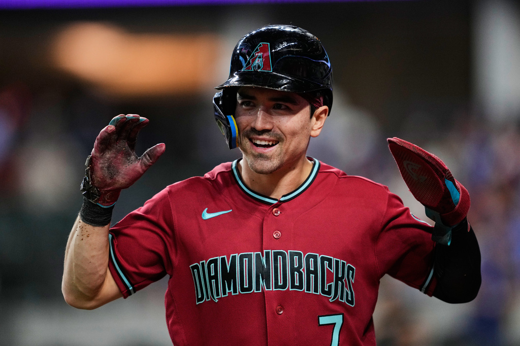 Arizona Diamondbacks' Corbin Carroll celebrates after scoring on a Geraldo Perdomo double in the first inning of a baseball game against the Texas Rangers Monday, May 11, 2026, in Arlington, Texas. (AP Photo/Tony Gutierrez)