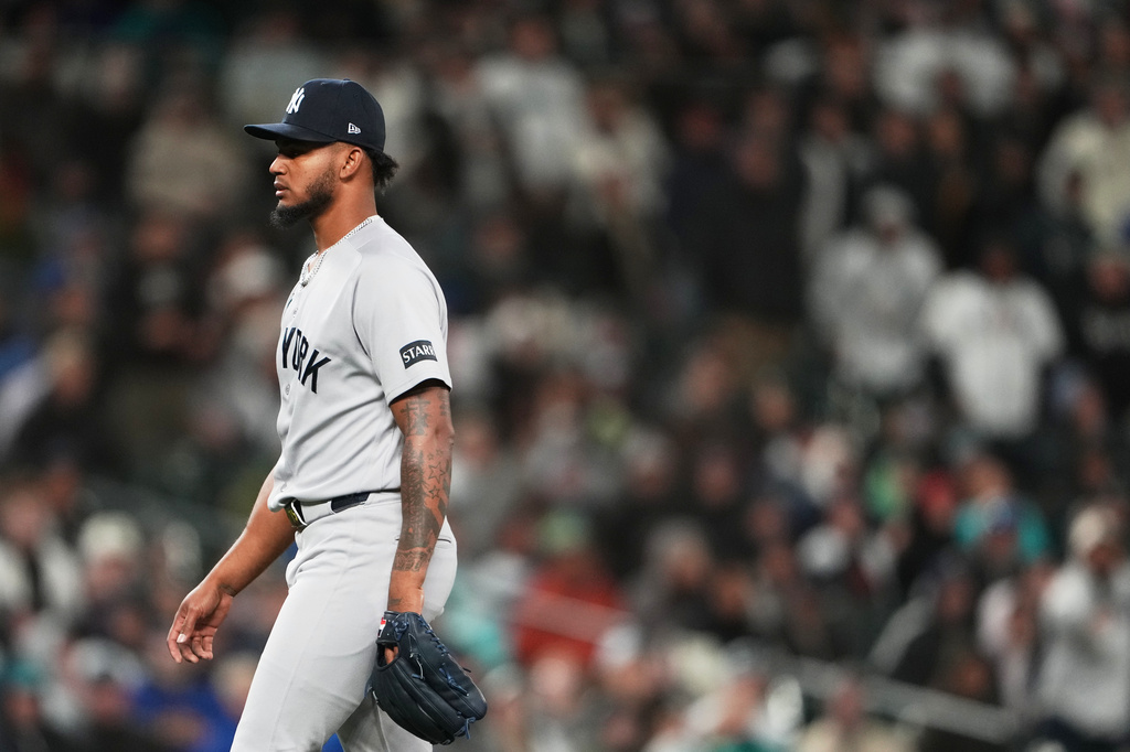 New York Yankees relief pitcher Camilo Doval walks to the dugout after retiring the side against the Seattle Mariners during the seventh inning of a baseball game, Monday, March 30, 2026, in Seattle. (AP Photo/Lindsey Wasson)