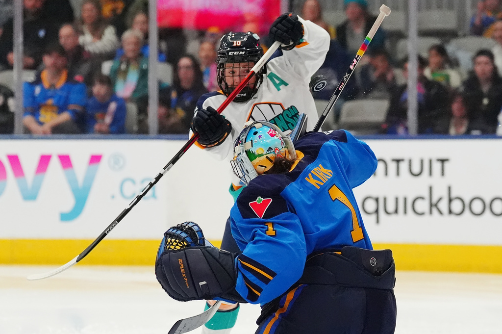 Toronto Sceptres goaltender Raygan Kirk (1) makes a save as New York Sirens' Sarah Fillier (10) tries to get her stick on the puck during first period PWHL hockey game in Toronto on Tuesday, April 21, 2026. (Frank Gunn/The Canadian Press via AP)
