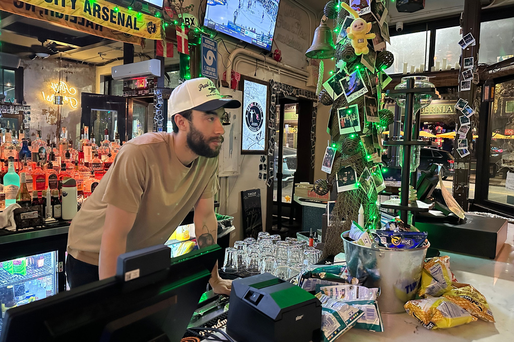 Evan Duke, a 30-year-old bartender who lives in Raleigh, N.C., works at the Pearl & Peril, March 10, 2026, in the city's Glenwood South bar district. (AP Photo/Bill Barrow)