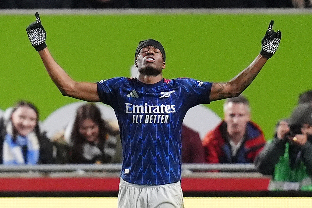 Arsenal's Noni Madueke celebrates scoring their side's first goal during the English Premier League soccer match between Brentford and Arsenal in London, Thursday, Feb. 12, 2026. (John Walton/PA via AP)