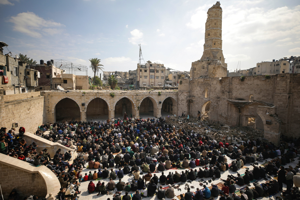FILE - Palestinians gather to attend Friday prayers at the Great Omari Mosque, which was damaged during the Israeli military's air and ground operation in Gaza City, Friday, Feb. 14, 2025. (AP Photo/Jehad Alshrafi, File)