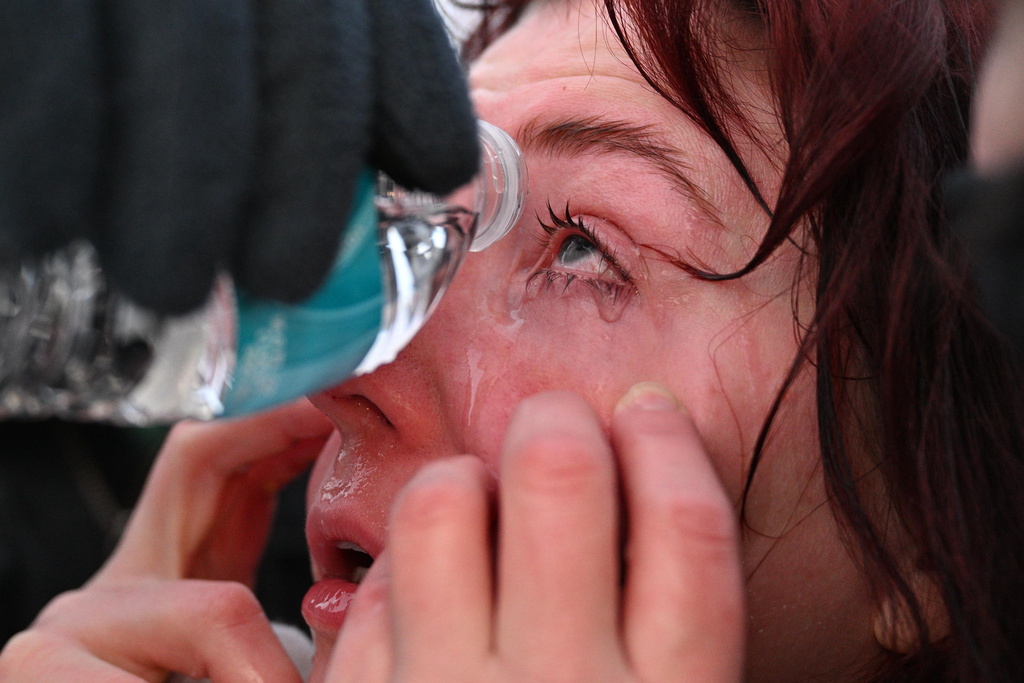 A protester receives aid after confronting law enforcement outside the Bishop Henry Whipple Federal Building, Thursday, Jan. 8, 2026, in Minneapolis, Minn. (AP Photo/Tom Baker)