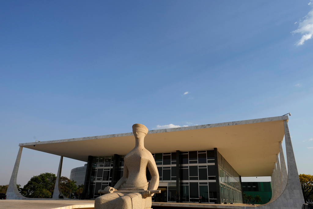 FILE - The Statue of Justice stands in front of the Supreme Court during the verdict and sentencing phase of a trial for those charged in an alleged coup plot to keep Brazil's former President Jair Bolsonaro in office after his 2022 election defeat, in Brasilia, Brazil, Sept. 11, 2025. (AP Photo/Eraldo Peres, File)