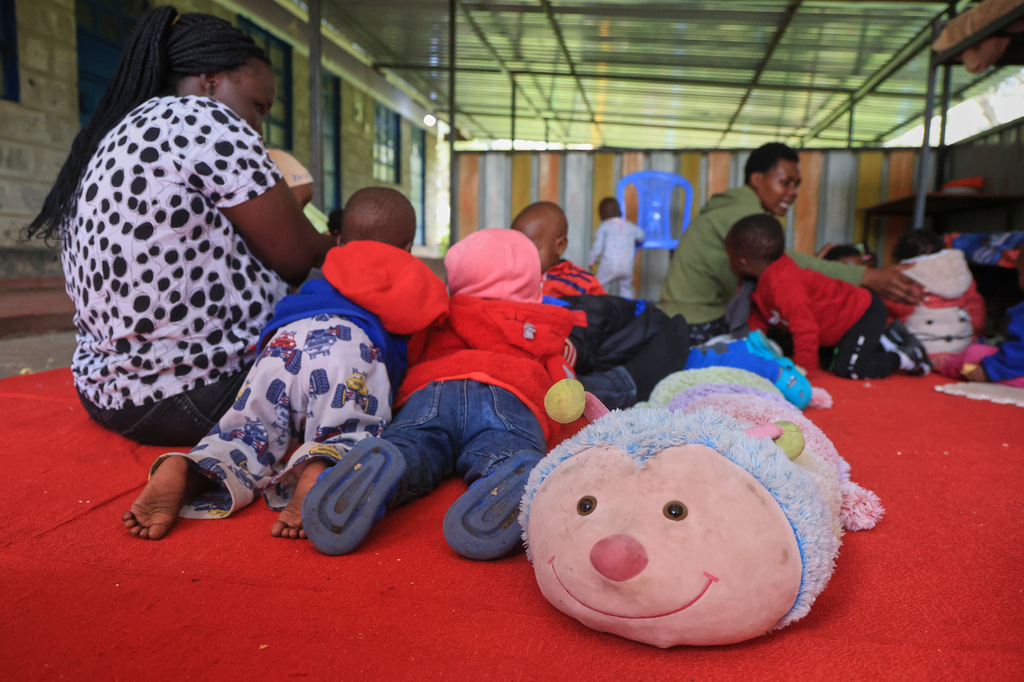 Caregivers interact with children at Greenland Girls School in Kajiado, Kenya, Thursday, March 5, 2026. (AP Photo/Andrew Kasuku)