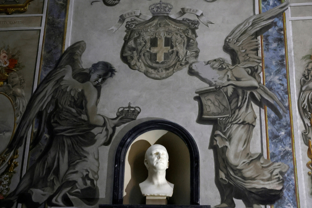 A painting inside the Basilica of San Lorenzo in Lucina in Rome depicting a cherub, right, that bore a striking resemblance to Italian Premier Giorgia Meloni shows signs of alteration after the face was removed, Wednesday, Feb. 4, 2026. (Cecilia Fabiano/LaPresse via AP)