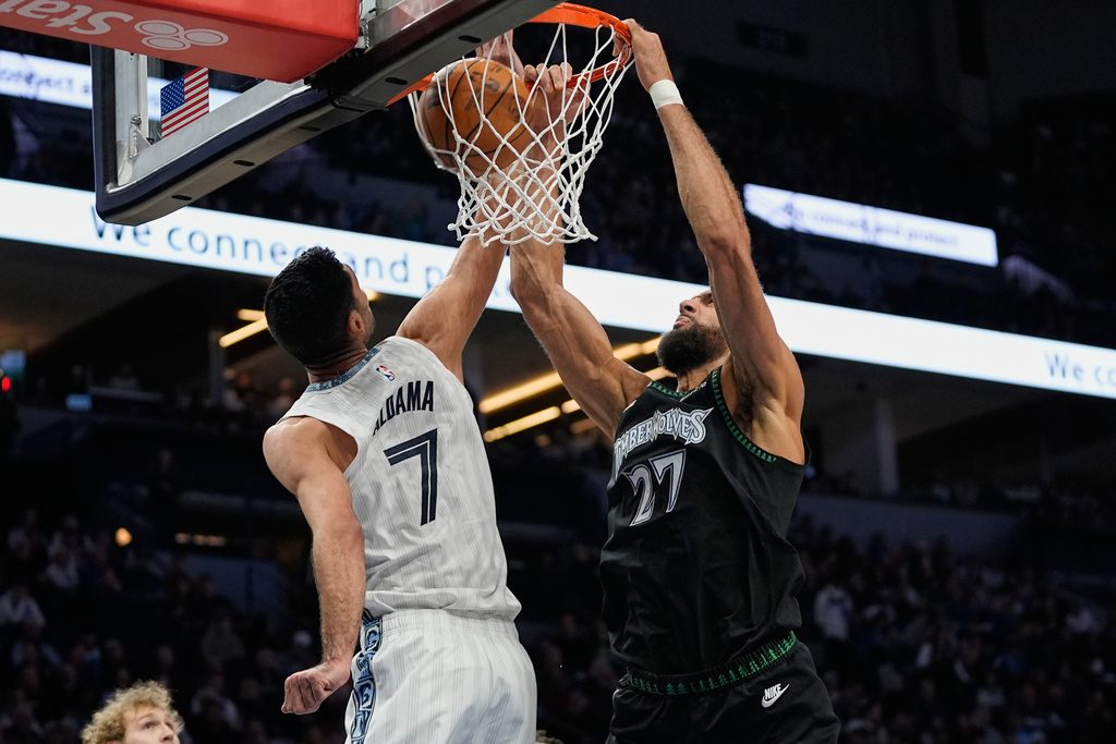 Minnesota Timberwolves center Rudy Gobert (27) dunks against Memphis Grizzlies forward Santi Aldama (7) during the first half of an NBA basketball game, Wednesday, Dec. 17, 2025, in Minneapolis. (AP Photo/Abbie Parr)