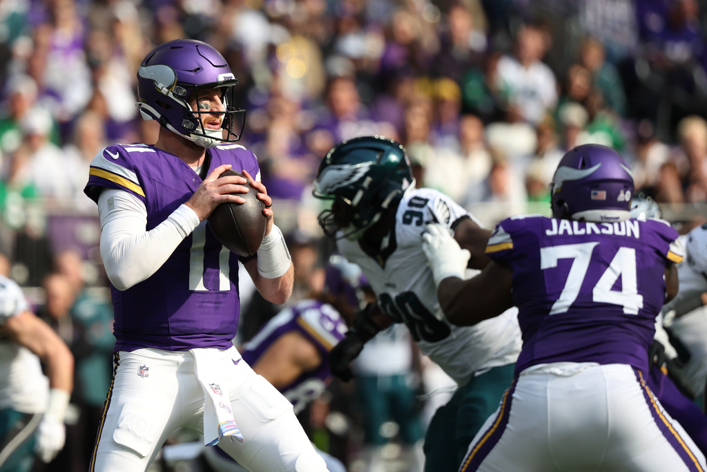 Minnesota Vikings quarterback Carson Wentz (11) prepares to throw a pass during the first half of an NFL football game against the Philadelphia Eagles, Sunday, Oct. 19, 2025, in Minneapolis. (AP Photo/Ellen Schmidt)