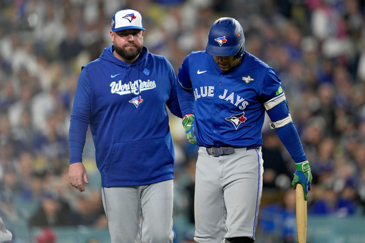 Toronto Blue Jays manager John Schneider helps George Springer off the field with an injury during the seventh inning in Game 3 of baseball's World Series against the Los Angeles Dodgers, Monday, Oct. 27, 2025, in Los Angeles. (AP Photo/Ashley Landis) Toronto Blue Jays manager John Schneider helps George Springer off the field with an injury during the seventh inning in Game 3 of baseball's World Series against the Los Angeles Dodgers, Monday, Oct. 27, 2025, in Los Angeles. (AP Photo/Ashley Landis)