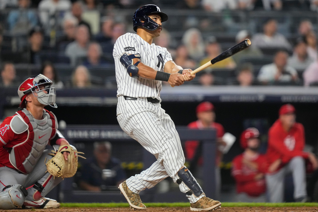 New York Yankees' Trent Grisham, right, watches his three-run home run during the fifth inning of a baseball game against the Los Angeles Angels, Monday, April 13, 2026, in New York. (AP Photo/Yuki Iwamura)