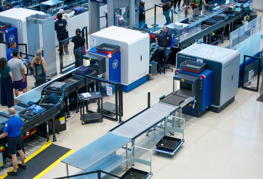 Travelers wait in line as several screening lines are closed at Louis Armstrong International Airport in Kenner, La. Monday, March 23, 2026. (David Grunfeld/The New Orleans Advocate via AP)