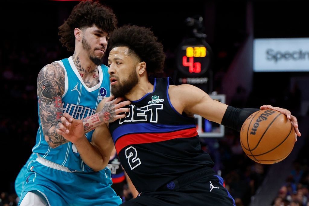 Detroit Pistons guard Cade Cunningham (2) drives against Charlotte Hornets guard LaMelo Ball, left, during the first half of an NBA basketball game in Charlotte, N.C., Monday, Feb. 9, 2026. (AP Photo/Nell Redmond)