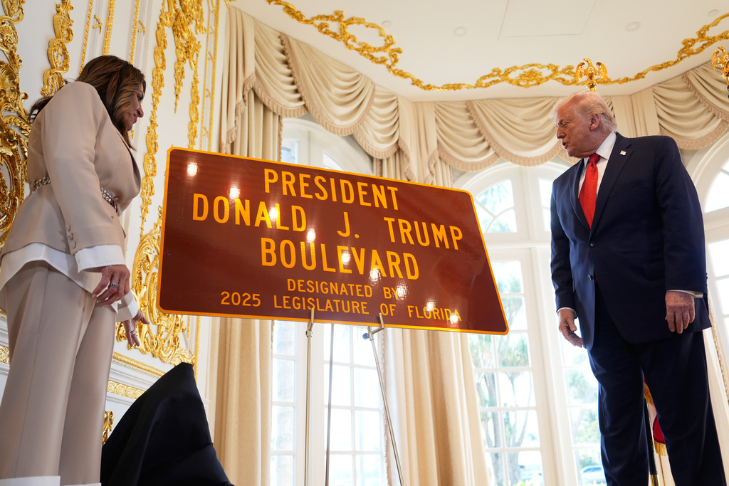 Florida Rep. Meg Weinberger, R-Palm Beach Gardens, left, presents President Donald Trump with a sign during a dedication ceremony for a portion of Southern Boulevard, which the Town of Palm Beach Council recently voted to rename,"President Donald J. Trump Boulevard," Friday, Jan. 16, 2026, at his Mar-a-Lago Club in Palm Beach, Fla. (AP Photo/Julia Demaree Nikhinson)