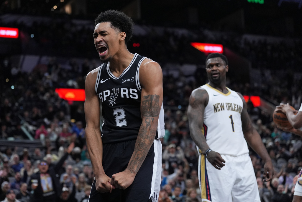 San Antonio Spurs guard Dylan Harper (2) reacts after he was fouled while scoring against New Orleans Pelicans forward Zion Williamson (1) during the second half of an NBA basketball game in San Antonio, Sunday, Jan. 25, 2026. (AP Photo/Eric Gay)