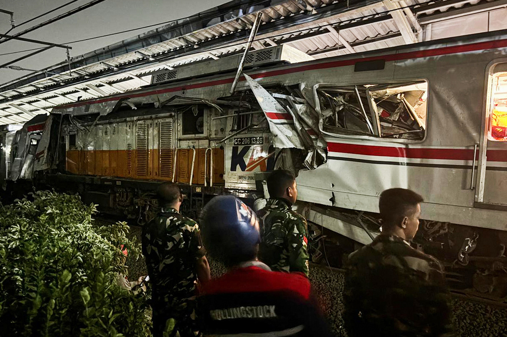 Indonesian soldiers examine the damage after a train crash at a station, in Bekasi, Indonesia, Tuesday, April 28, 2026. (AP Photo/Fadlan Syam)