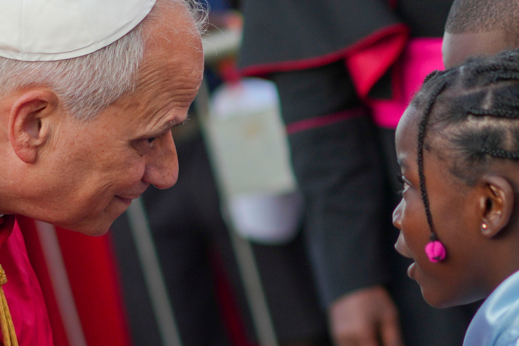 Pope Leo XIV listens to a girl as he arrives at the Parish of Our Lady of Fatima in Luanda, Angola, for a meeting with bishops, priests, consecrated men and women, and pastoral workers Monday, April 20, 2026, on the eighth day of an 11-day apostolic journey to Africa (AP Photo/Andrew Medichini)