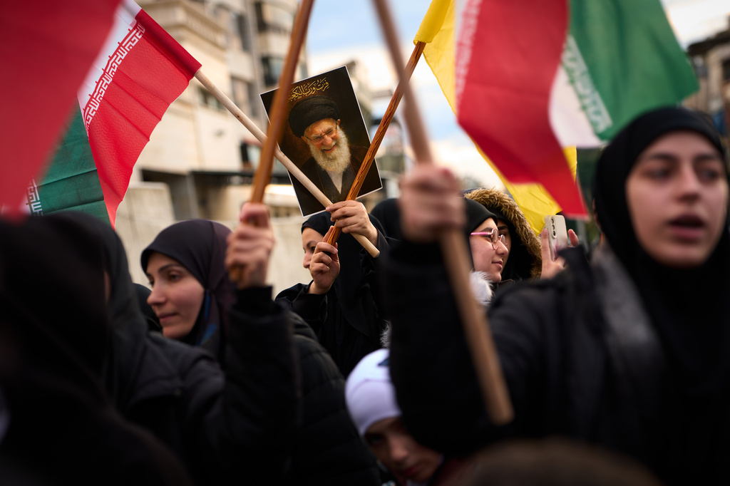 A woman holds a portrait of Iran's late Supreme Leader Ayatollah Ali Khamenei during a protest outside Iran's embassy, where dozens of people gathered waving Hezbollah and Iranian flags in solidarity with the Islamic Republic, in Beirut, Lebanon, Thursday, March 26, 2026. (AP Photo/Emilio Morenatti)