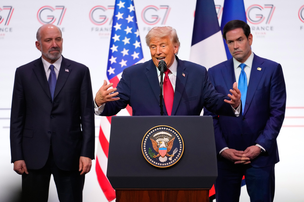 U.S. President Donald Trump, center, speaks as he is flanked by, U.S. Secretary of Commerce Howard Lutnick, left, and United States Secretary of State Marco Rubio during a media conference at the end of the G7 summit in Evian-les-Bains, France, Wednesday, June 17, 2026. (AP Photo/Vadim Ghirda)