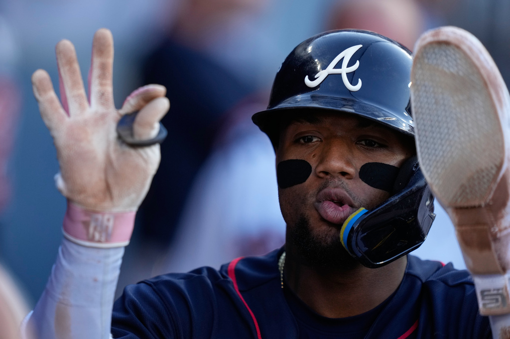 Atlanta Braves' Ronald Acu&ntilde;a Jr. celebrates with teammates after scoring off an RBI single by Mauricio Dub&oacute;n during the first inning of Game 2 of a National League Division Series baseball game against the Los Angeles Dodgers Sunday, Oct. 4, 2026, in Los Angeles. (AP Photo/Mark J. Terrill)