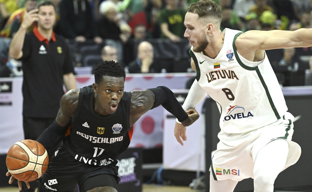 Germany's Dennis Schroeder, left, and Lithuania's Tadas Sedekerskis in action during the basketball FIBA EuroBasket 2025 group B match between Lithuania and Germany in Tampere, Finland, Saturday Aug. 30, 2025. (Heikki Saukkomaa/Lehtikuva via AP)