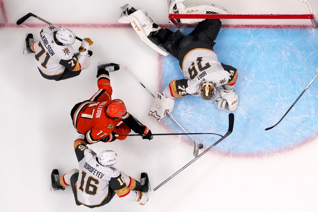 Anaheim Ducks left wing Alex Killorn (17) tires to get a shot past Vegas Golden Knights goaltender Carter Hart (79) as center William Karlsson (71) and right wing Pavel Dorofeyev (16) defend during the third period in Game 6 of a second-round NHL hockey Stanley Cup playoff series Thursday, May 14, 2026, in Anaheim, Calif. (AP Photo/Mark J. Terrill)