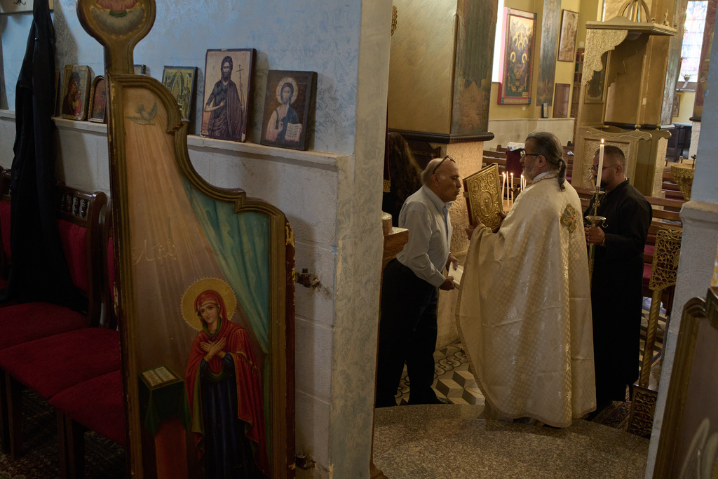 Greek Orthodox parish priest David Khoury attends morning Mass at St. George church in the West Bank village of Taybeh, Sept. 28, 2025. (AP Photo/Leo Correa)