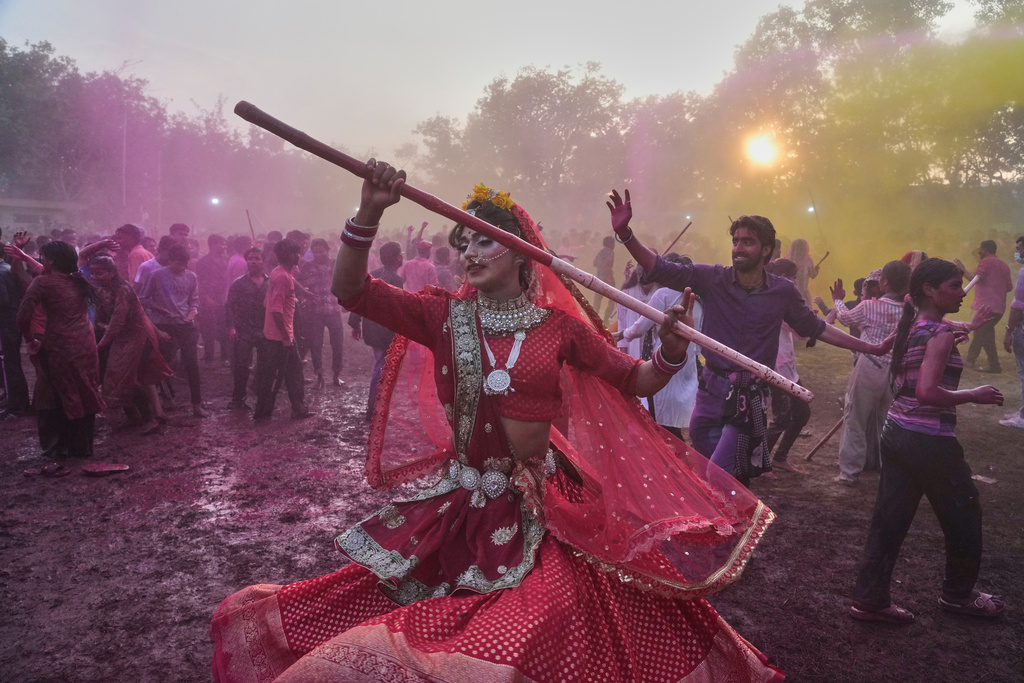 A member of transgender community dances during Holi festival celebrations at the Shri Krishna Janmabhoomi Temple complex in Mathura, India, on Feb. 27, 2026. (AP Photo/Manish Swarup)