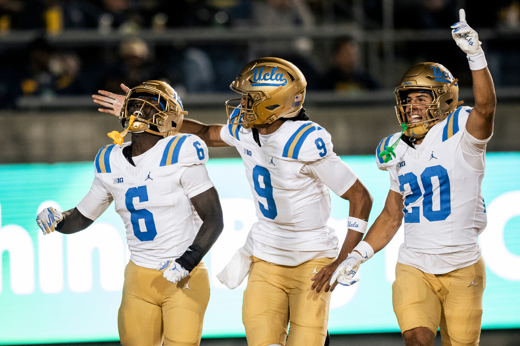 UCLA running back Anthony Woods (6) celebrates with teammates quarterback Nico Iamaleava (9) and wide receiver Shane Rosenthal (20) during the first half of their NCAA football game against California in Berkeley, Calif., on Saturday, Sept. 5, 2026. (Stephen Lam/San Francisco Chronicle via AP)