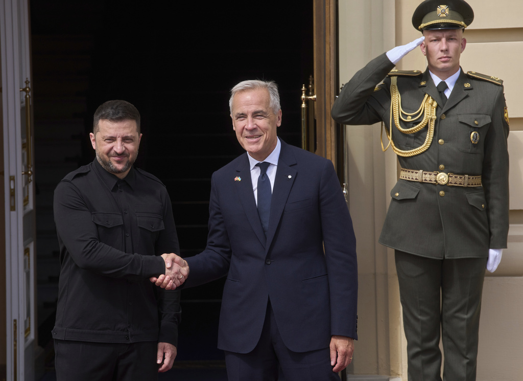Canadian Prime Minister Mark Carney, right, shakes hands with Ukrainian President Volodymyr Zelenskyy during their meeting in Kyiv, Ukraine, Sunday, Aug. 24, 2025. (AP Photo/Efrem Lukatsky)