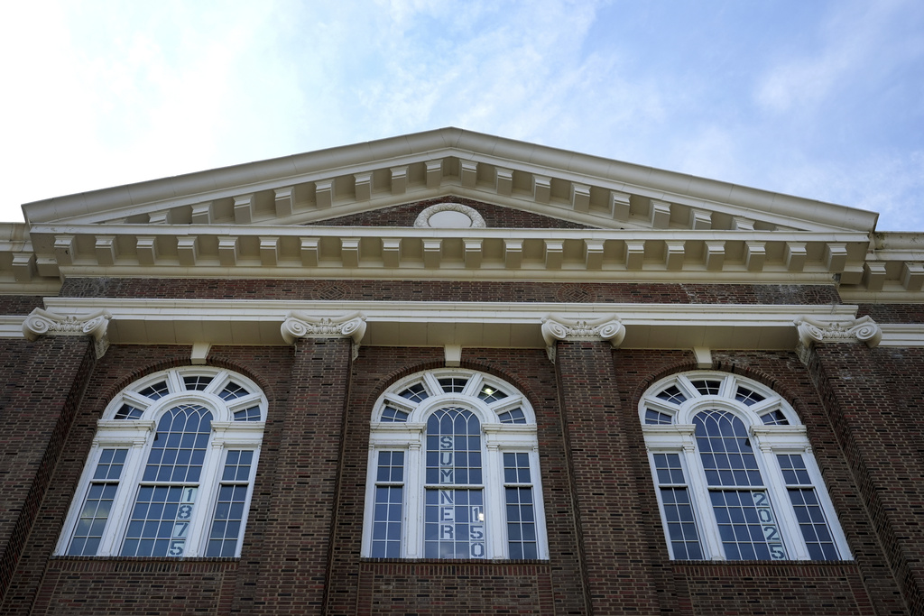 Signs are seen in windows celebrating 150 years of Sumner High School, the first Black high school west of the Mississippi, Sept. 18, 2025, in St. Louis. (AP Photo/Jeff Roberson)