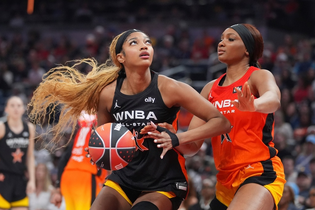 FILE - Chicago Sky's Angel Reese, left, shoots against Washington Mystics' Kiki Iriafen during the second half of a WNBA All-Star basketball game, July 19, 2025, in Indianapolis. (AP Photo/Michael Conroy, File)