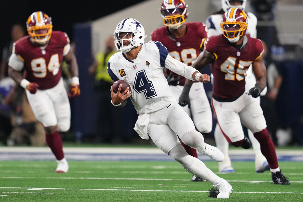 Dallas Cowboys quarterback Dak Prescott (4) runs against the Washington Commanders in the second half during an NFL football game in Arlington, Texas, Sunday, Sept. 20, 2026. (AP Photo/Tony Gutierrez)