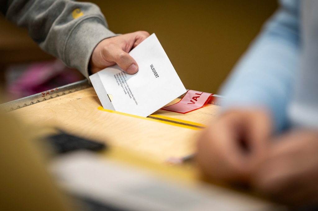 A ballot envelope is placed in a ballot box at a polling station at the City Hall in Malmo, Sweden, Sunday, Sept. 13, 2026. (Johan Nilsson/TT News Agency via AP)