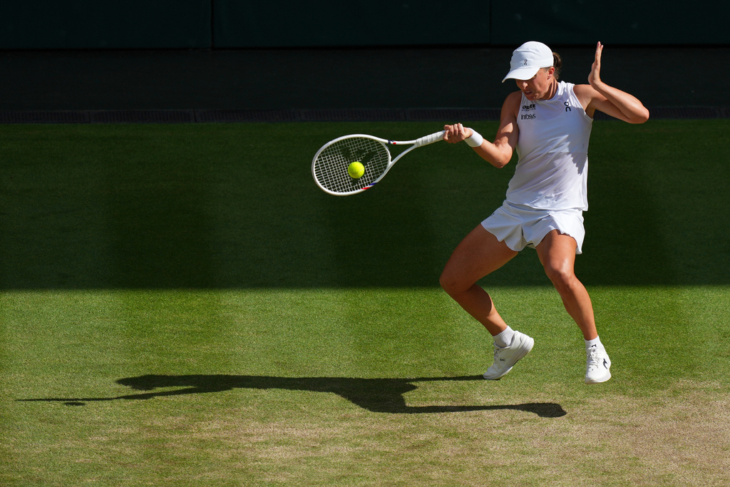 FILE -Iga Swiatek of Poland returns to Amanda Anisimova of the U.S. during the women's singles final match at the Wimbledon Tennis Championships in London, July 12, 2025.(AP Photo/Joanna Chan, File)