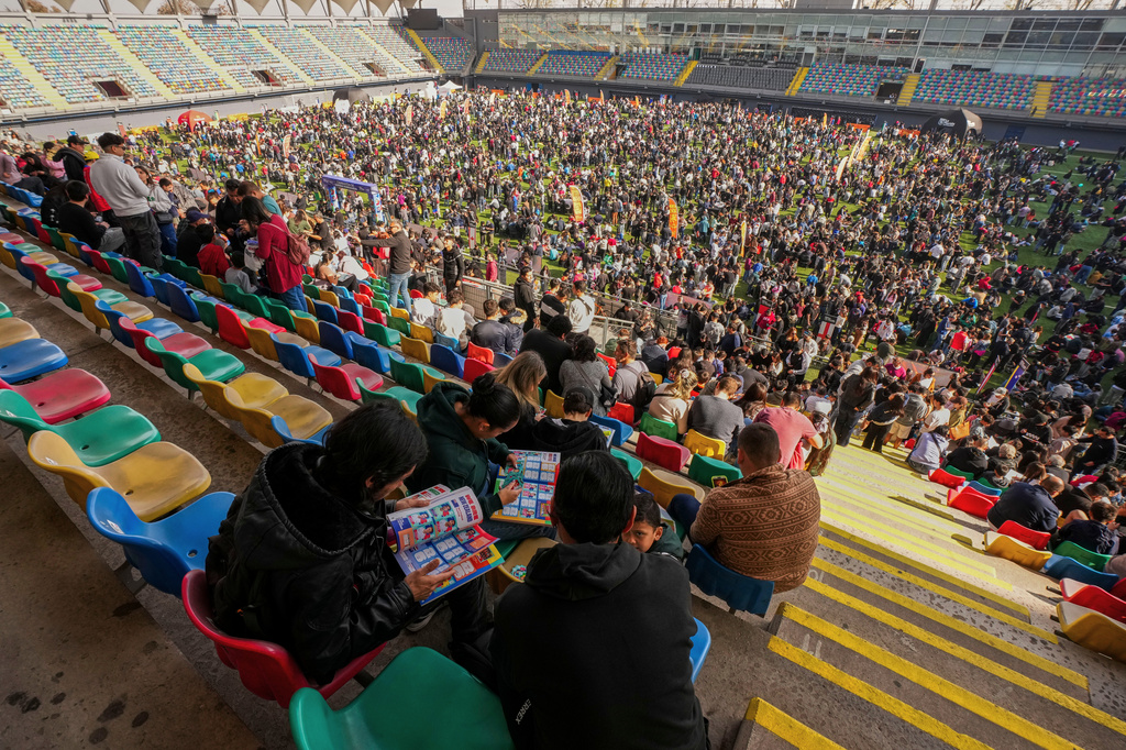 Soccer fans gather to trade Panini World Cup sticker albums and trading cards at the Bicentenario de La Florida stadium in Santiago, Chile, Sunday, May 31, 2026. (AP Photo/Esteban Felix)