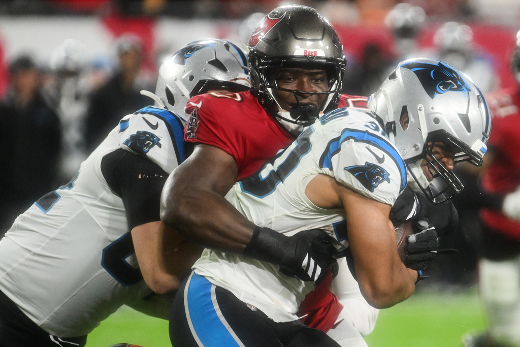 Tampa Bay Buccaneers linebacker Yaya Diaby, top, tackles Carolina Panthers running back Chuba Hubbard during the second half of an NFL football game Saturday, Jan. 3, 2026, in Tampa, Fla. (AP Photo/Jason Behnken)