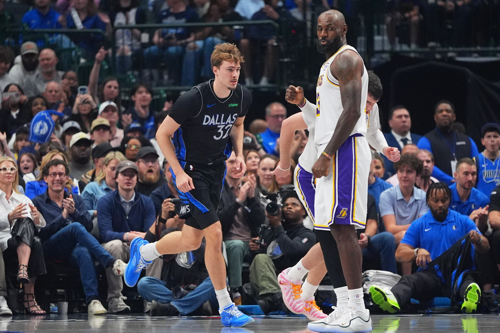 Dallas Mavericks forward Cooper Flagg (32) runs past Los Angeles Lakers forward LeBron James (23) during the first half of an NBA basketball game in Dallas, Sunday, April 5, 2026. (AP Photo/LM Otero)