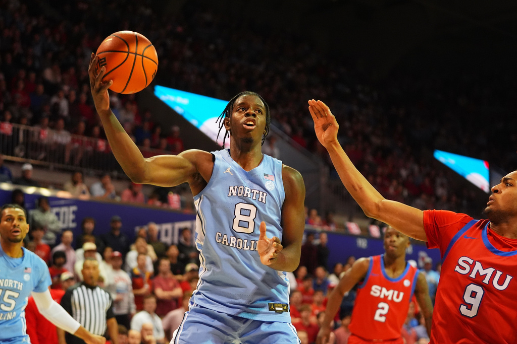 North Carolina forward Caleb Wilson (8) drives against SMU forward B.J. Davis-Ray (9) during the first half of an NCAA college basketball game Saturday, Jan. 3, 2026, in Dallas. (AP Photo/LM Otero)