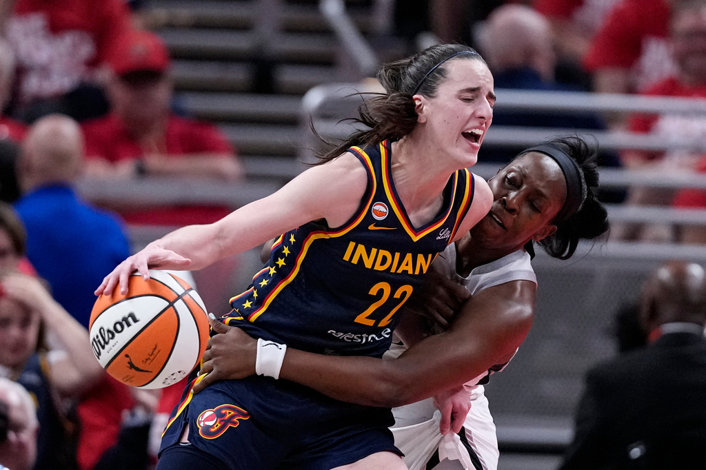 Las Vegas Aces guard Chelsea Gray, right, defends Indiana Fever guard Caitlin Clark (22) during the second half in Game 2 of a WNBA basketball first-round playoff series in Indianapolis, Tuesday, Sept. 29, 2026. (AP Photo/Michael Conroy)