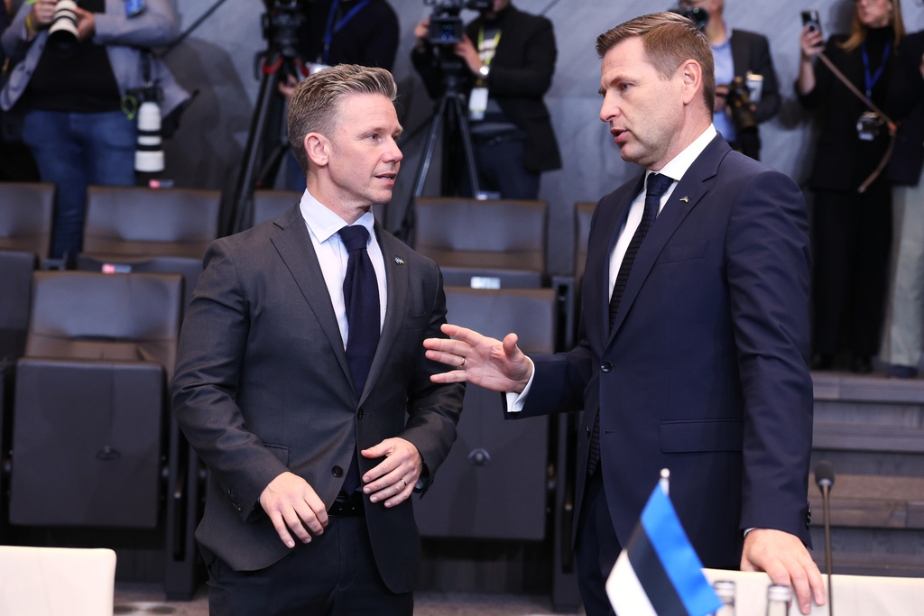 Sweden's Defense Minister Pal Jonson, left, speaks with Estonia's Defense Minister Hanno Pevkur during a meeting of the North Atlantic Council in defense ministers format at NATO headquarters in Brussels, Wednesday, Oct. 15, 2025 (AP Photo/Omar Havana)
