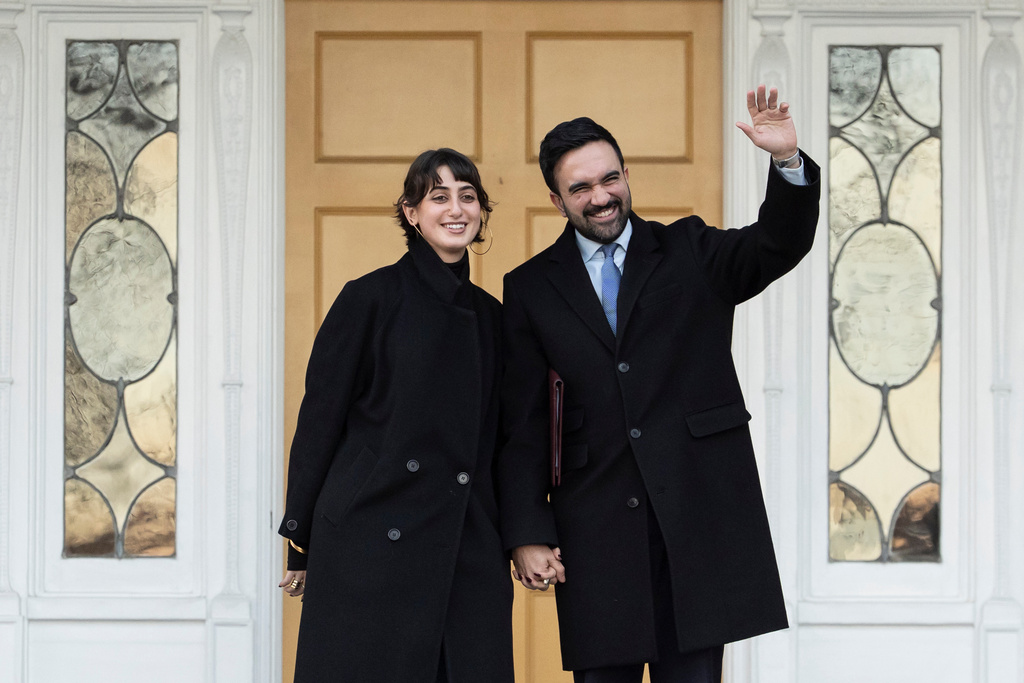 New York Mayor Zohran Mamdani, right, and his wife Rama Duwaji wave at members of media after a news conference at Gracie Mansion, Monday, Jan. 12, 2026, in New York. (AP Photo/Yuki Iwamura)